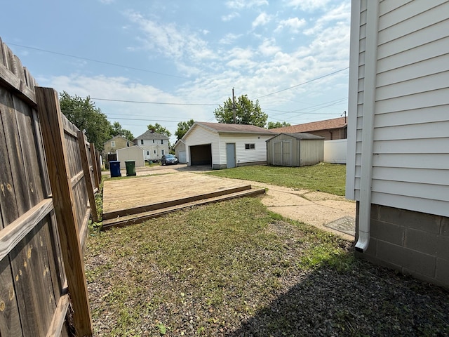 2612 3rd Ave W, Hibbing, MN 55746 - view of yard with a shed, a detached garage, and a wooden deck