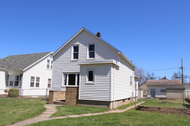 2612 3rd Ave W, Hibbing, MN 55746 - rear view of house featuring a chimney