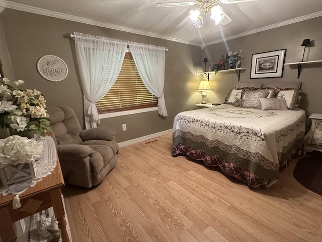 bedroom featuring wood finished floors, baseboards, ceiling fan, and crown molding