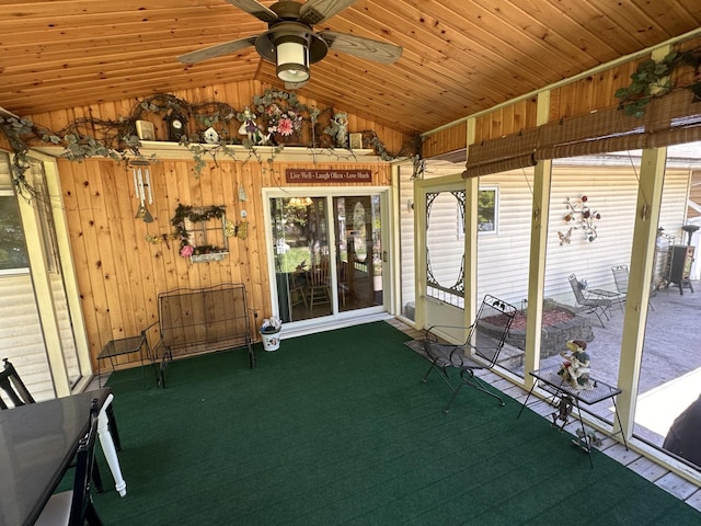 unfurnished sunroom with lofted ceiling and ceiling fan