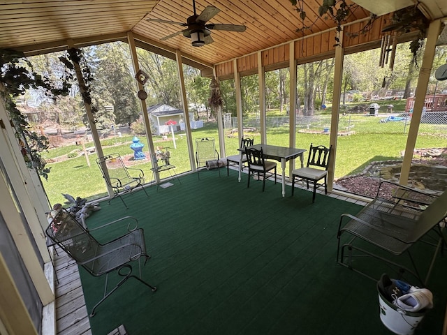 sunroom / solarium featuring lofted ceiling, ceiling fan, and plenty of natural light