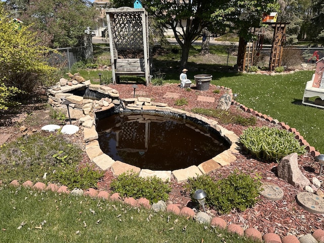 view of yard featuring a small pond