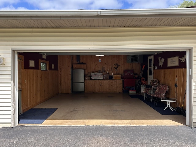 827 124th Ln NE, Blaine, MN 55434 - garage featuring freestanding refrigerator and driveway