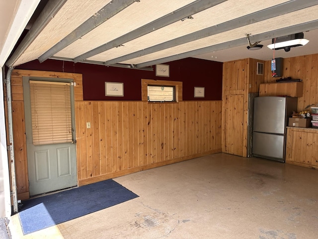 827 124th Ln NE, Blaine, MN 55434 - garage with freestanding refrigerator, wood walls, and wainscoting