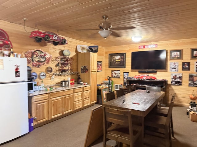 303 4th St S, Hoffman, MN 56339 - kitchen featuring freestanding refrigerator, light colored carpet, wood walls, wood ceiling, and a ceiling fan
