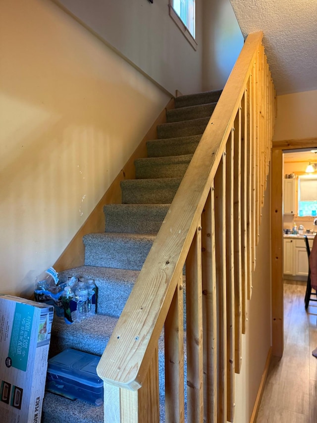 303 4th St S, Hoffman, MN 56339 - stairs with a textured ceiling and wood finished floors