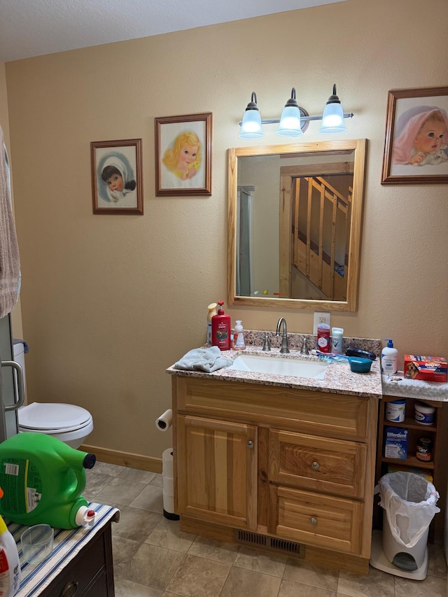 303 4th St S, Hoffman, MN 56339 - bathroom featuring vanity, toilet, and baseboards
