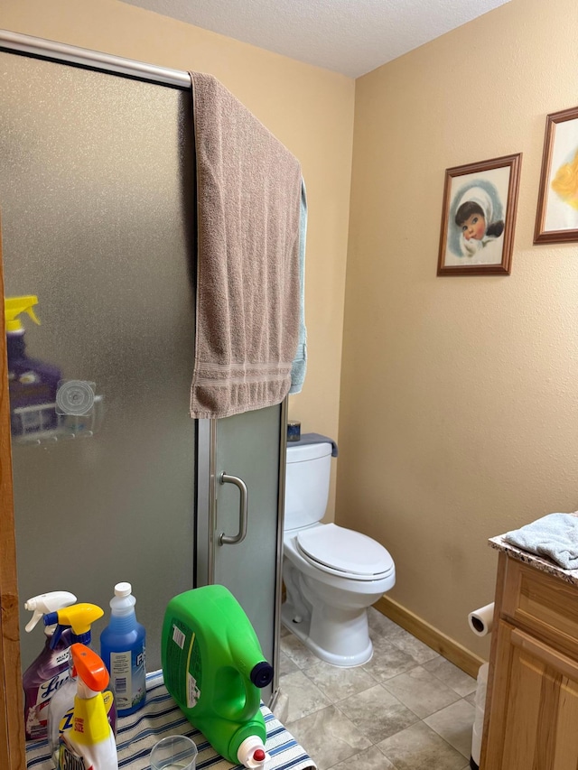 303 4th St S, Hoffman, MN 56339 - full bathroom featuring a stall shower, toilet, baseboards, vanity, and tile patterned flooring