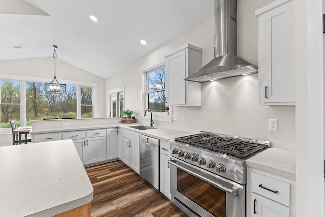 6359 313th Ave NE, North Branch, MN 55056 - kitchen with appliances with stainless steel finishes, a sink, wall chimney exhaust hood, a chandelier, and light countertops