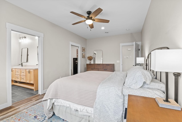 6359 313th Ave NE, North Branch, MN 55056 - bedroom with dark wood-type flooring, recessed lighting, ceiling fan, ensuite bathroom, and a sink