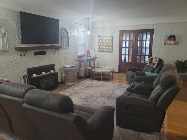 living room featuring wood finished floors and a textured wall
