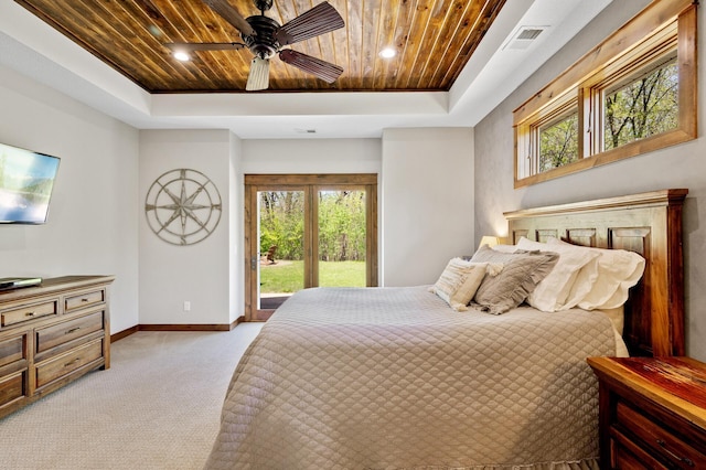 bedroom with a tray ceiling, access to outside, wood ceiling, baseboards, and multiple windows