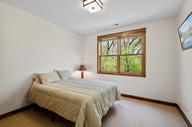 bedroom with multiple windows, baseboards, and carpet flooring