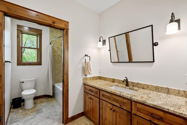 bathroom featuring baseboards, vanity, toilet, shower / bathtub combination with curtain, and stone finish flooring