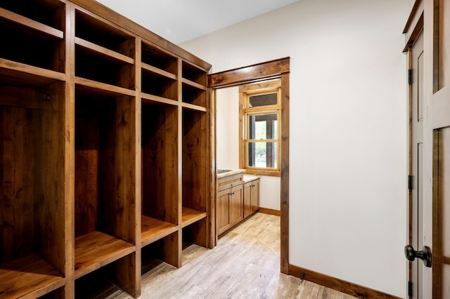 mudroom with baseboards and light wood-type flooring