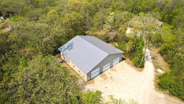 view from above of property with a heavily wooded area