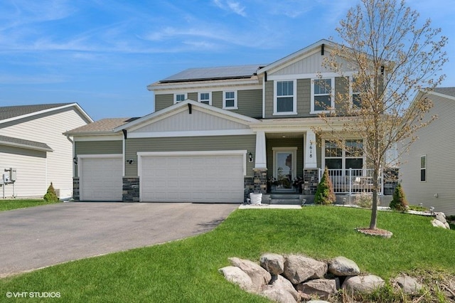 3618 112th Cir NE, Blaine, MN 55449 - craftsman house with a porch, driveway, roof mounted solar panels, a front lawn, and a garage