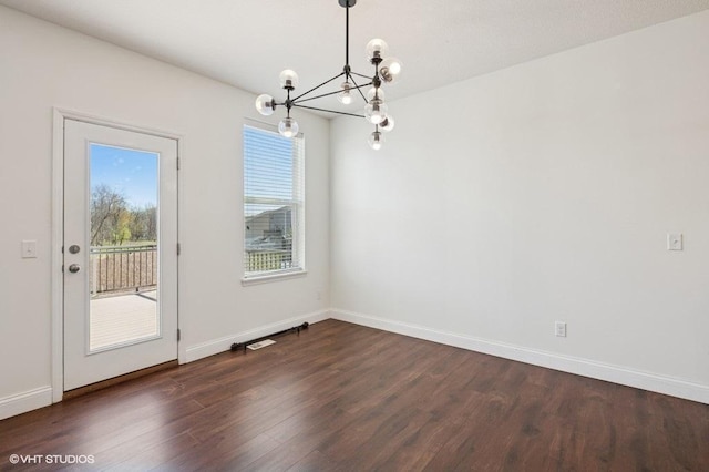 3618 112th Cir NE, Blaine, MN 55449 - unfurnished dining area featuring a chandelier, dark wood finished floors, and baseboards