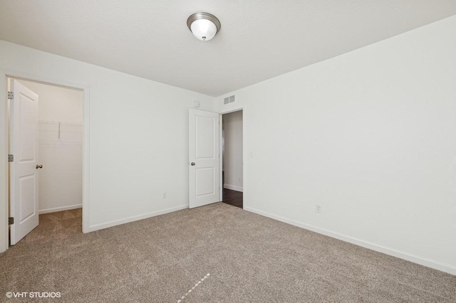 3618 112th Cir NE, Blaine, MN 55449 - unfurnished bedroom featuring carpet floors, a walk in closet, a closet, and baseboards