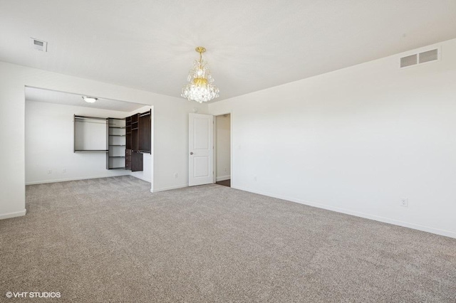 3618 112th Cir NE, Blaine, MN 55449 - empty room featuring light carpet, baseboards, and a chandelier