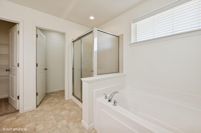 3618 112th Cir NE, Blaine, MN 55449 - full bathroom featuring a stall shower, a garden tub, a spacious closet, recessed lighting, and baseboards