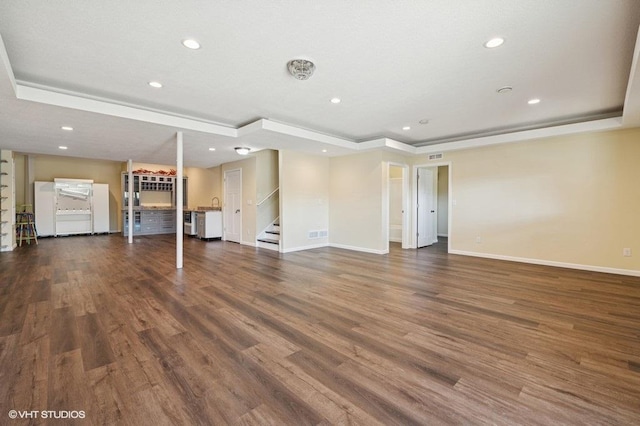 3618 112th Cir NE, Blaine, MN 55449 - unfurnished living room with a tray ceiling, stairway, baseboards, recessed lighting, and wood finished floors