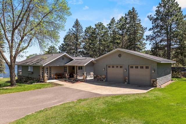 view of front of house with a front lawn, concrete driveway, a garage, stone siding, and roof with shingles