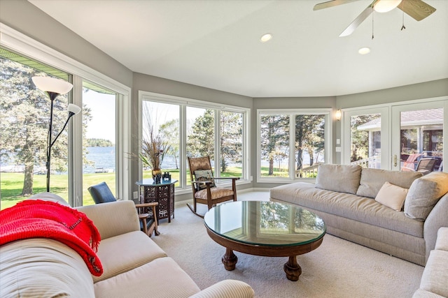 sunroom with a water view, carpet, and recessed lighting