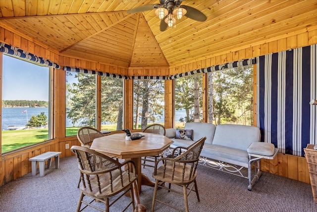 sunroom featuring ceiling fan, a water view, and lofted ceiling
