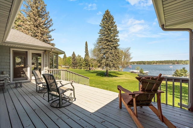 wooden terrace with a water view and a lawn