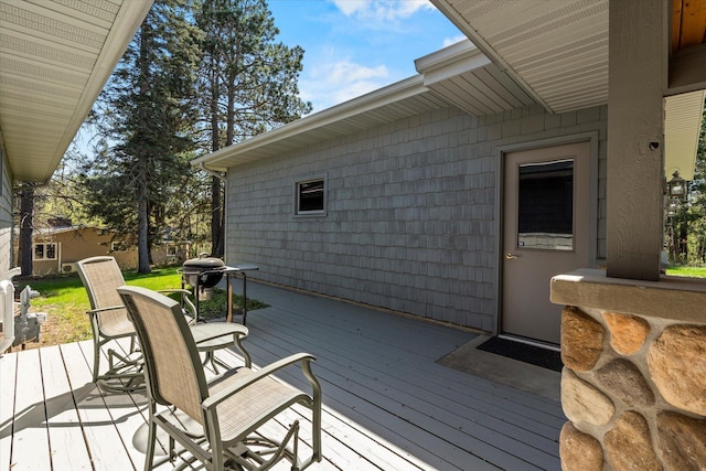 wooden terrace featuring a grill