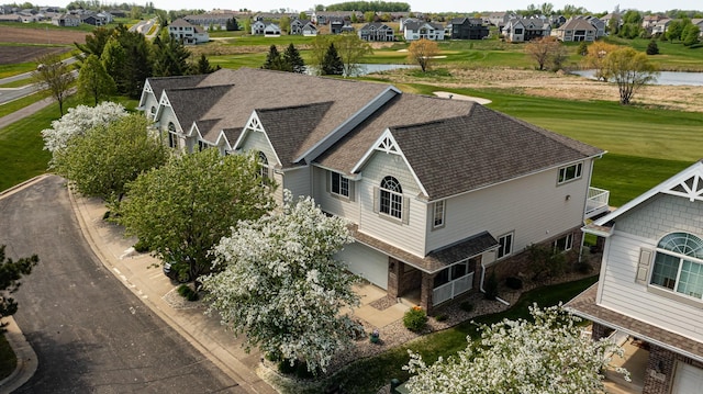aerial perspective of suburban area featuring a nearby body of water