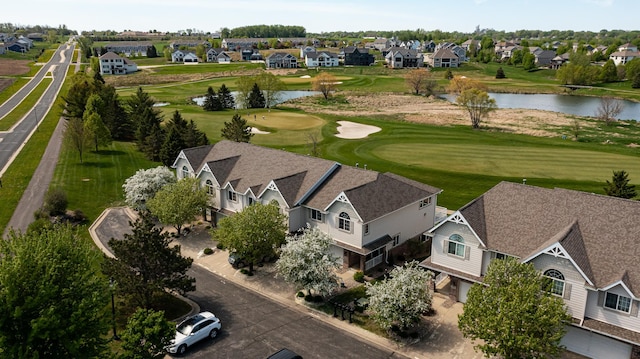 aerial perspective of suburban area featuring a nearby body of water and a local golf course