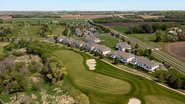 view of property location with a golf course and nearby suburban area