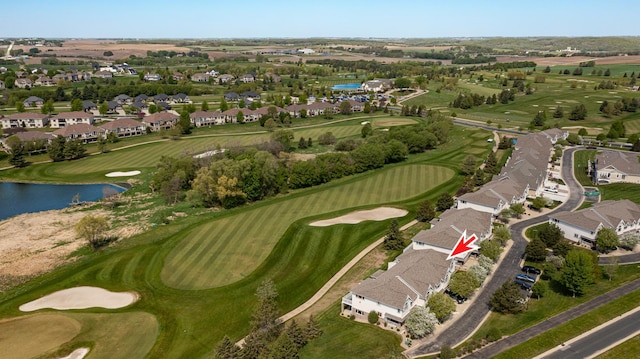 aerial view of property's location with a large body of water, a golf club, and nearby suburban area