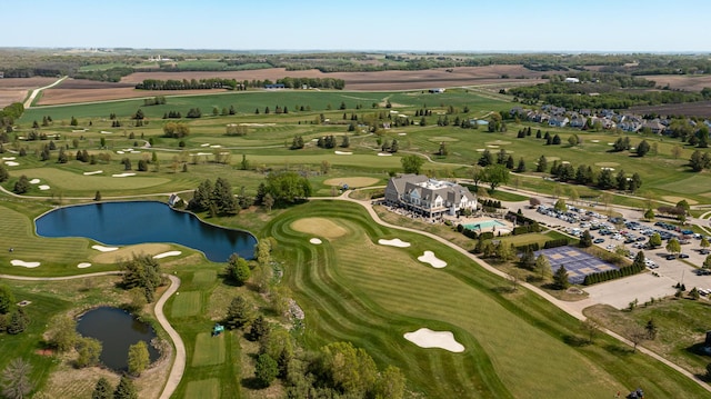aerial view of property's location with a nearby body of water and a golf course