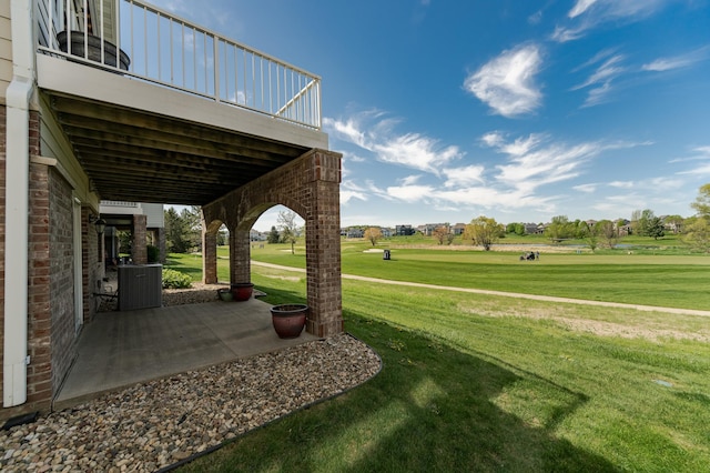 view of green lawn featuring a patio area
