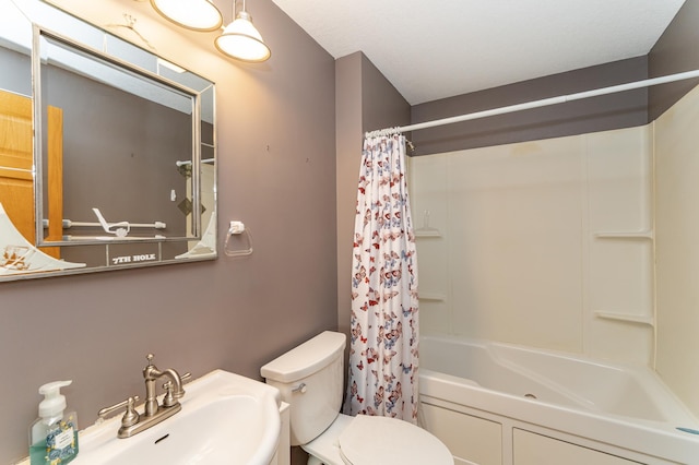 full bathroom with a sink, toilet, and shower / bath combo with shower curtain