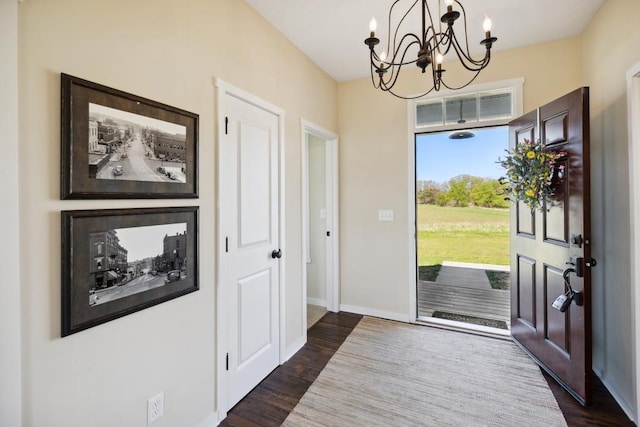 13985 120th St N, Stillwater Twp, MN 55082 - foyer featuring a chandelier, dark wood-type flooring, and baseboards