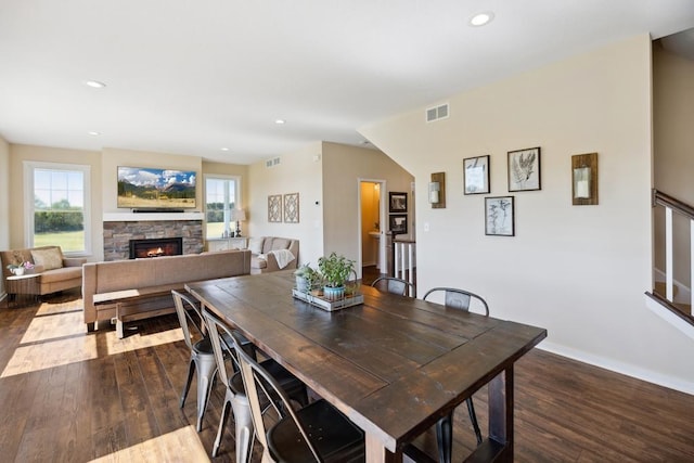 13985 120th St N, Stillwater Twp, MN 55082 - dining space with dark wood-type flooring, a stone fireplace, recessed lighting, and baseboards