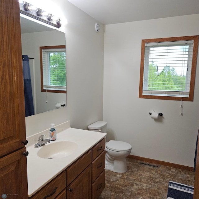 1171 Long Bridge Cir, Detroit Lakes, MN 56501 - full bathroom with toilet, vanity, baseboards, and stone finish floors