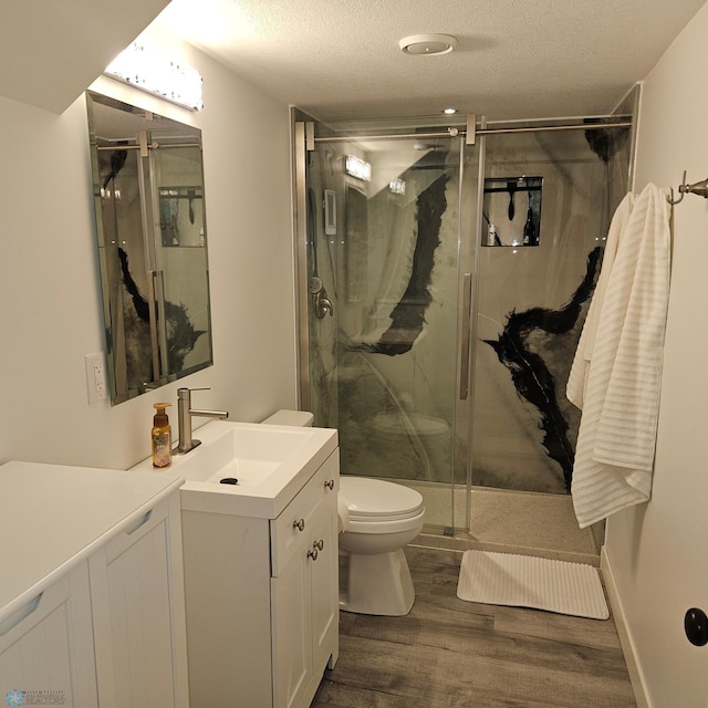 1171 Long Bridge Cir, Detroit Lakes, MN 56501 - bathroom with toilet, wood finished floors, vanity, a marble finish shower, and a textured ceiling