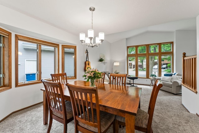 dining space featuring light colored carpet, a chandelier, lofted ceiling, and baseboards