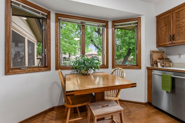 dining room with baseboards and light wood-style floors