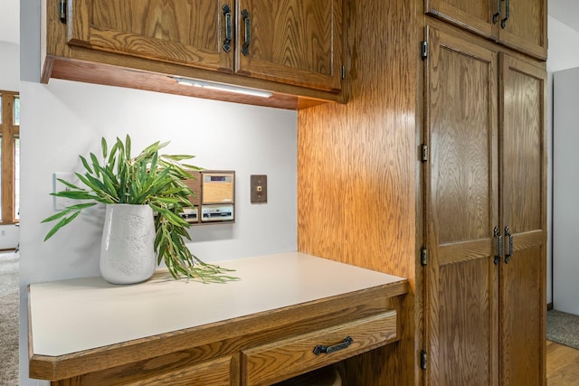kitchen view of brown cabinetry and light countertops