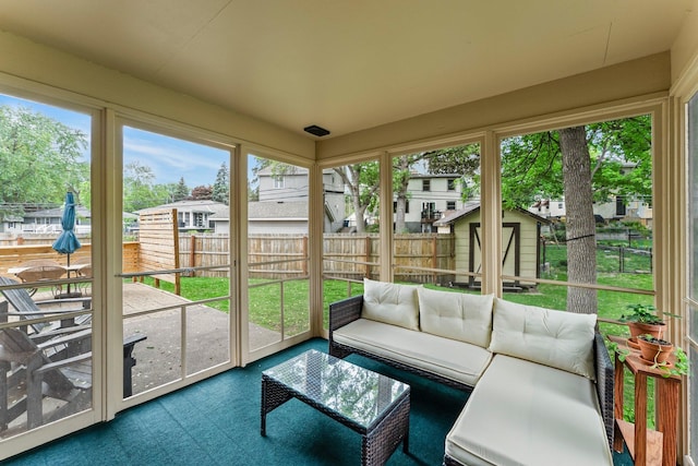 sunroom / solarium featuring an outdoor living space and a residential view