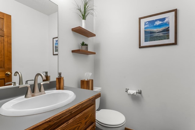 bathroom with toilet and vanity