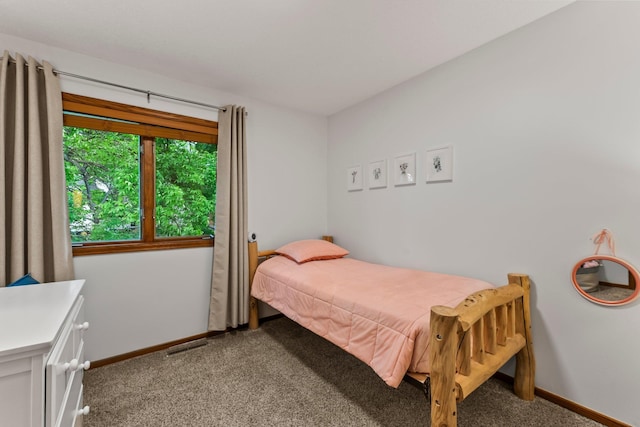 bedroom featuring baseboards and light carpet