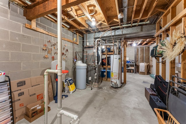 unfinished below grade area with water heater, a water softener system, and concrete block wall