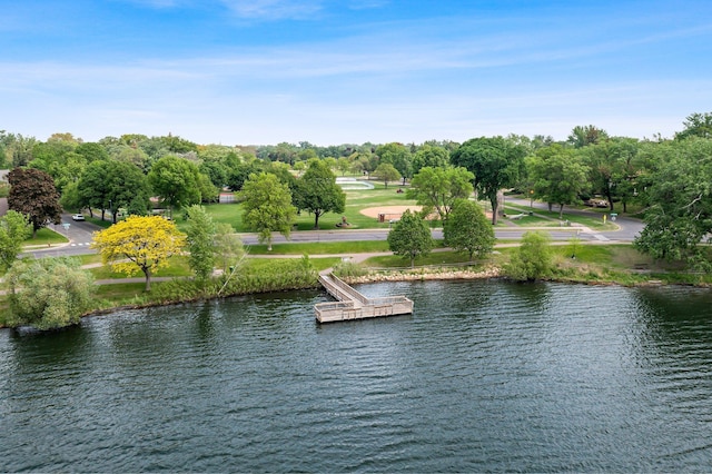 water view featuring a floating dock and a tree filled landscape